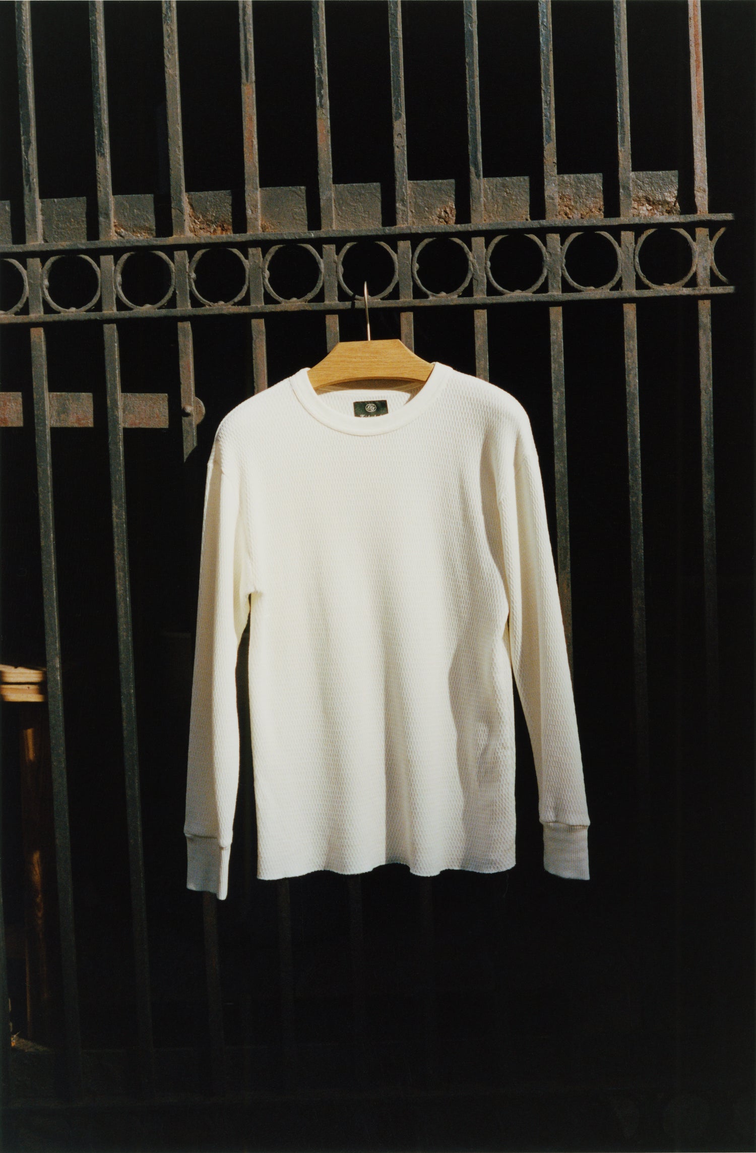 White themal hanging on a city fence in the sun.